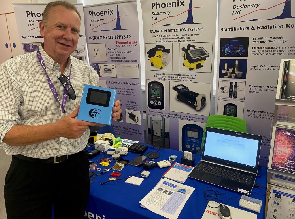Mike Sweeney from Phoenix Dosimetry at the AURPO Conference 2023 displaying new product CRM-LPT Radon and Air Quality Monitor